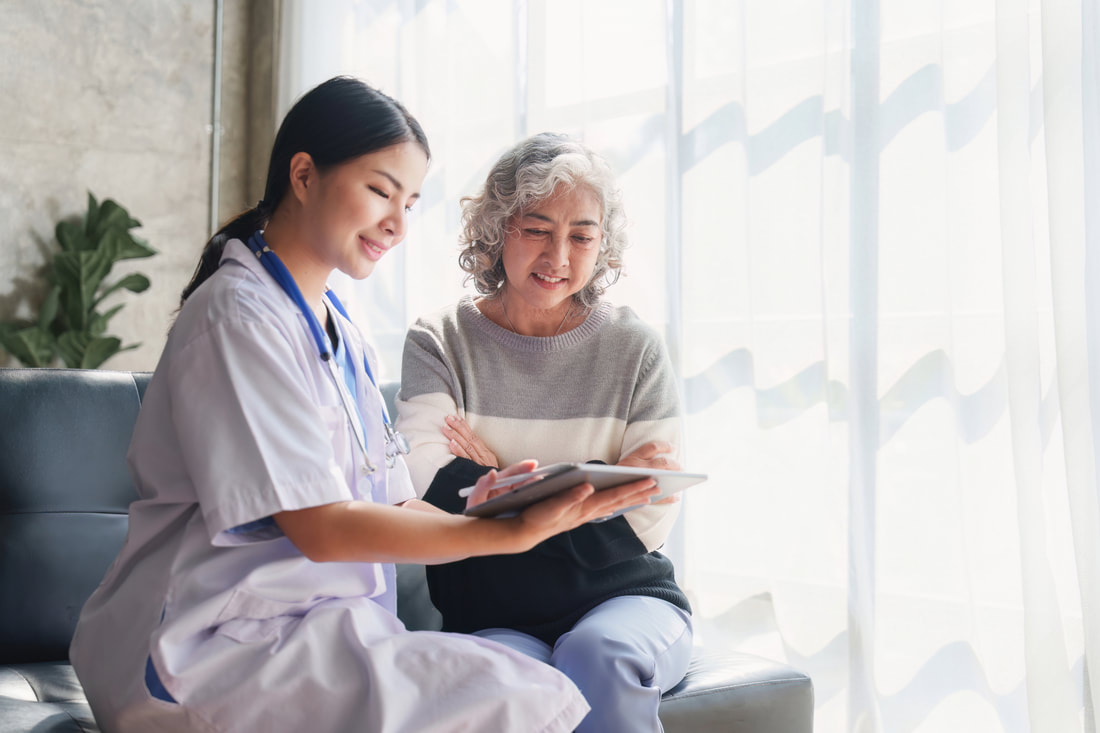 image of young asian woman reading with older woman